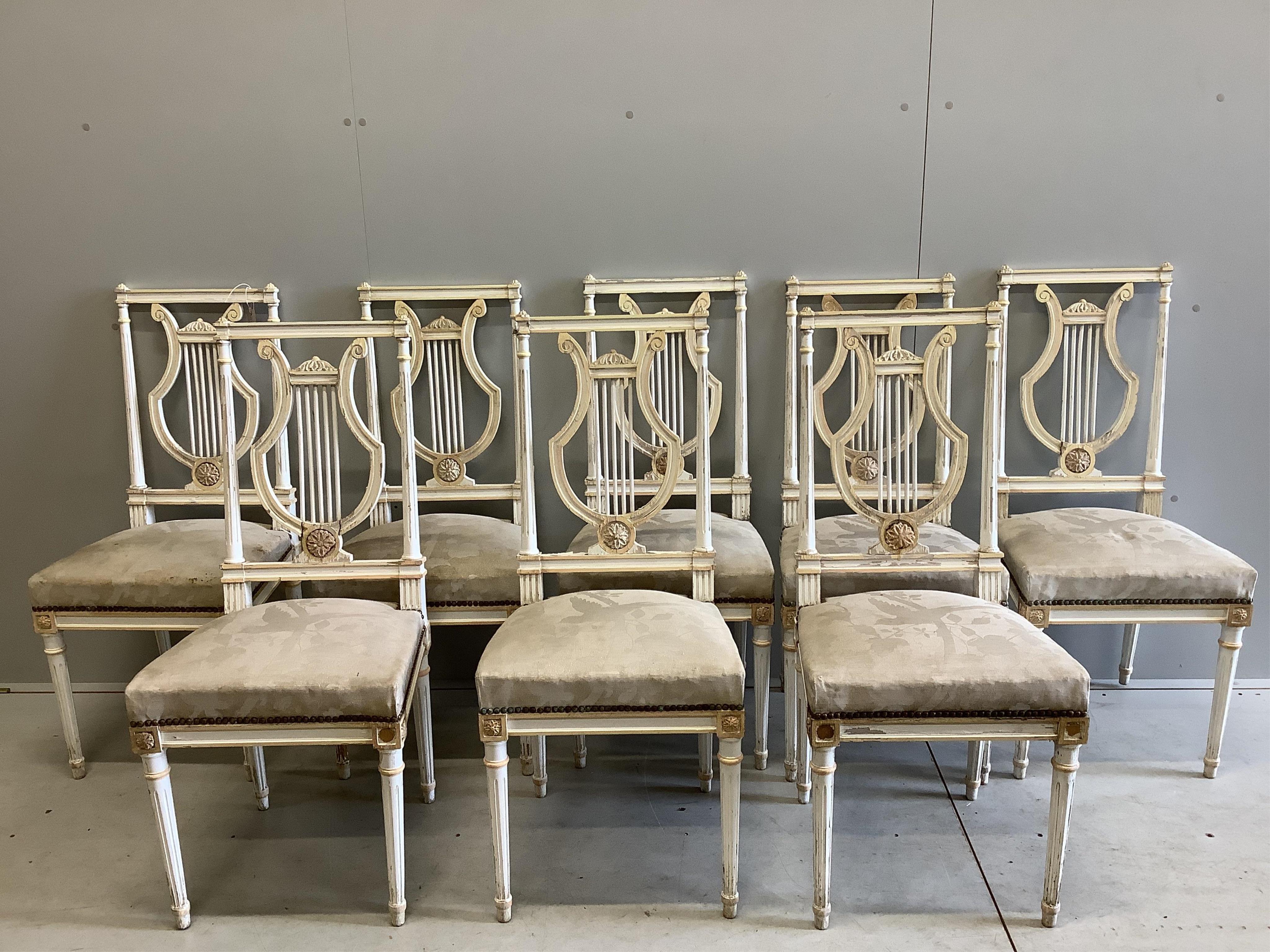 A set of eight Empire style painted lyre back chairs, width 43cm, height 99cm. Condition - fair